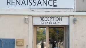 A hotel entrance with a reception desk, a sign reading "Hotel Renaissance," and two potted plants. - Hôtel Renaissance Martigues (Martigues)