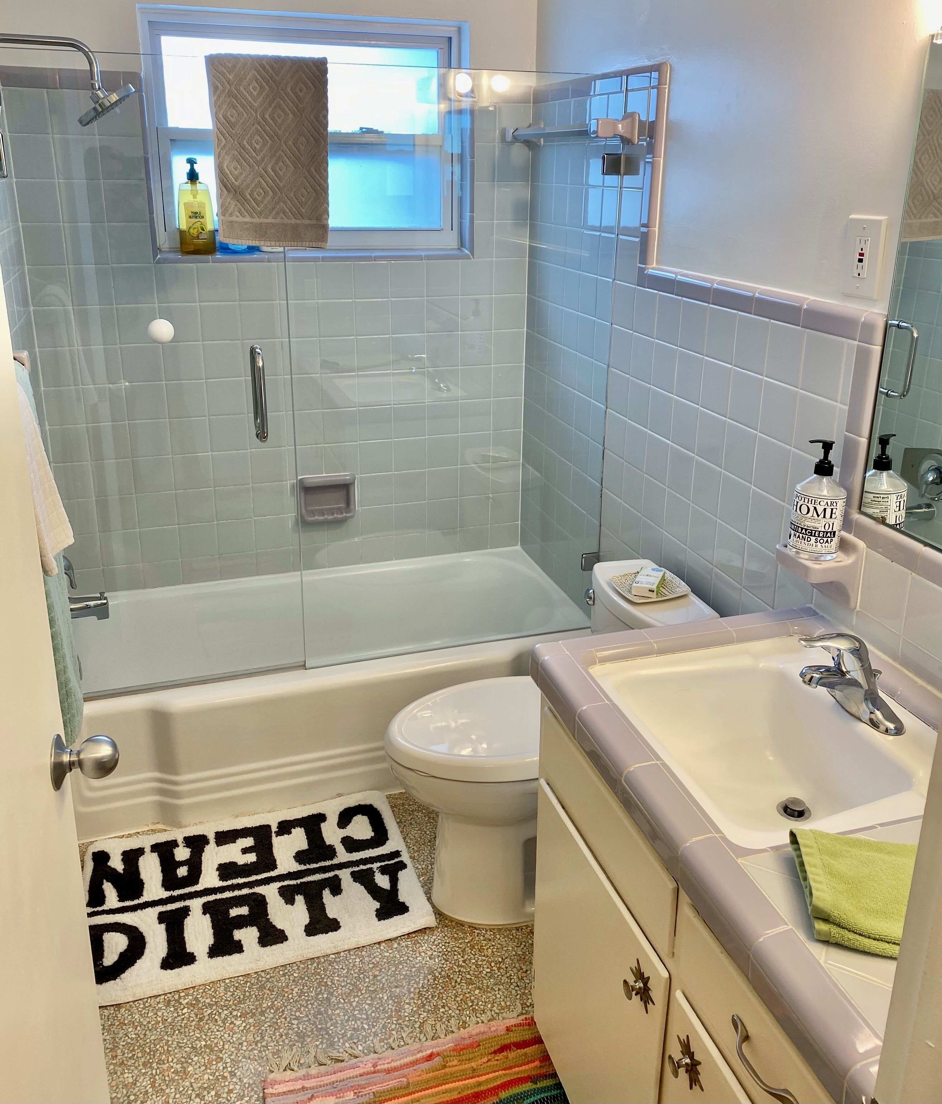 A bathroom with a bathtub, toilet, and sink.