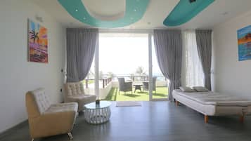 Deluxe Room, Pool View | Living room | 32-inch LED TV with premium TV channels, TV