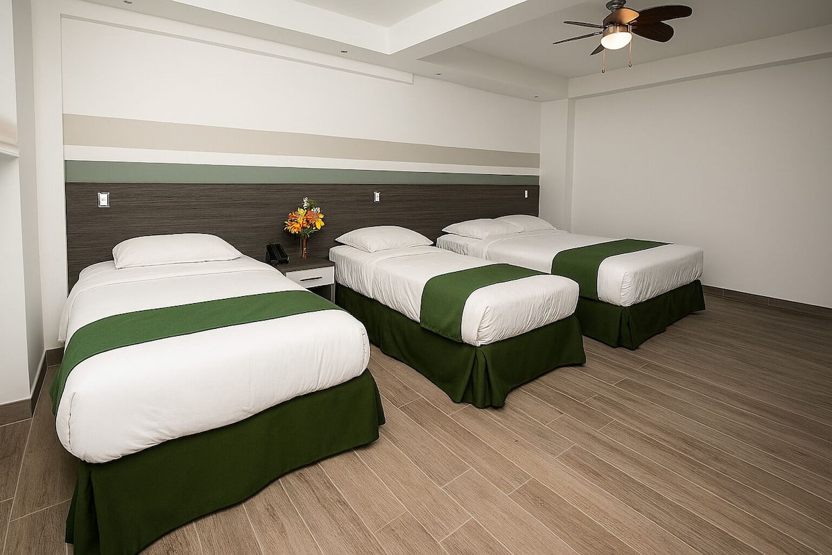 Deluxe Quadruple Room | Minibar, in-room safe, individually decorated, individually furnished