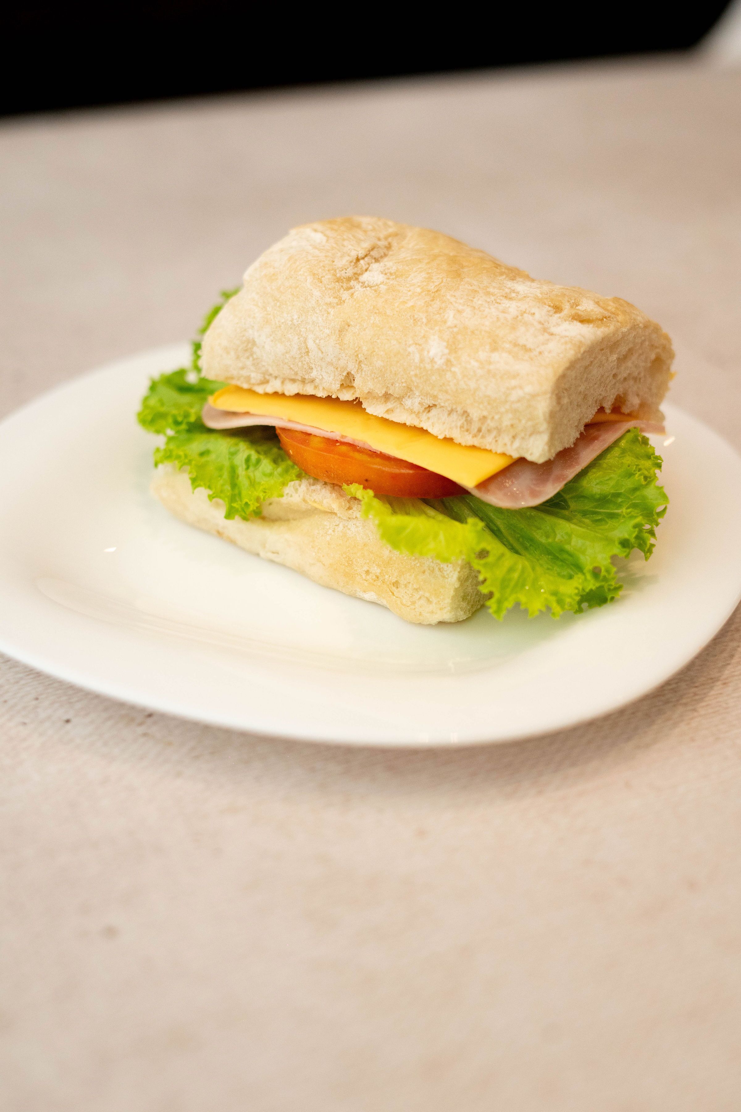 A sandwich on a white plate.