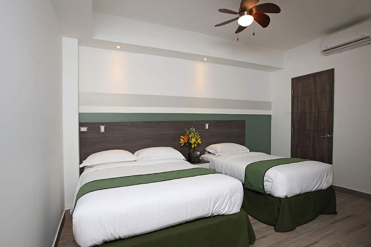 Deluxe Triple Room | Minibar, in-room safe, individually decorated, individually furnished