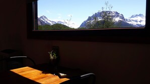 Une pièce avec une fenêtre donnant sur un paysage montagneux.