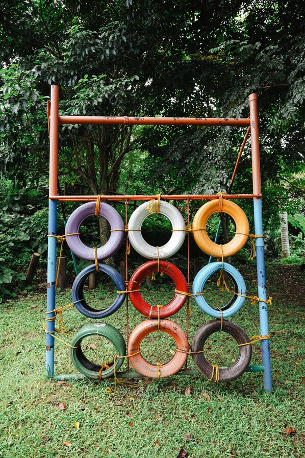Una estructura de juegos hecha con neumáticos y barras de metal de colores.