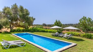 A rectangular swimming pool with clear blue water, surrounded by a well-maintained lawn and two umbrellas. - Ses Cases Son Blat, 5StarsHome Mallorca Estate (Manacor)