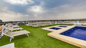 A rooftop pool area with multiple sun loungers and a central swimming pool. - SUNRISE Semiramis II Cruise (Luxor)