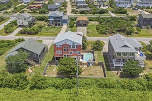 Un barrio residencial con casas, piscina y patio cercado.