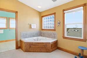Combined shower/bathtub, towels, soap, toilet paper - The After Glow | 940 ft from the beach | Private Pool, Hot Tub (Nags Head)