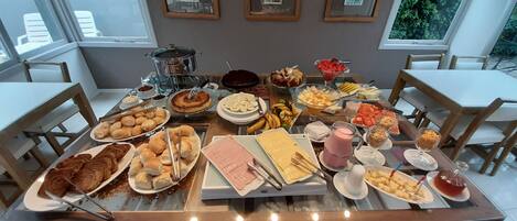 Un bufé de desayuno con diversas opciones de comida y una estación de café.