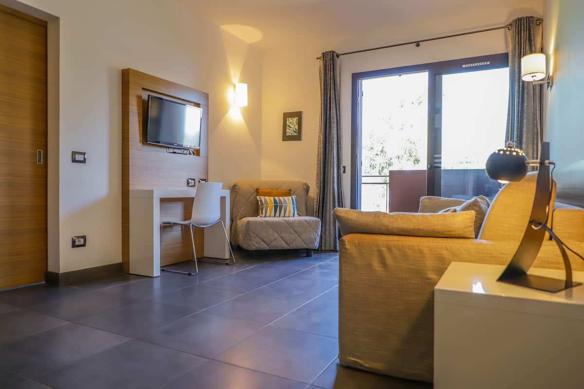 family room, sea view | living area | flat-screen tv