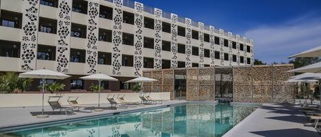 Seasonal outdoor pool, open 9:00 AM to 8:00 PM, pool umbrellas