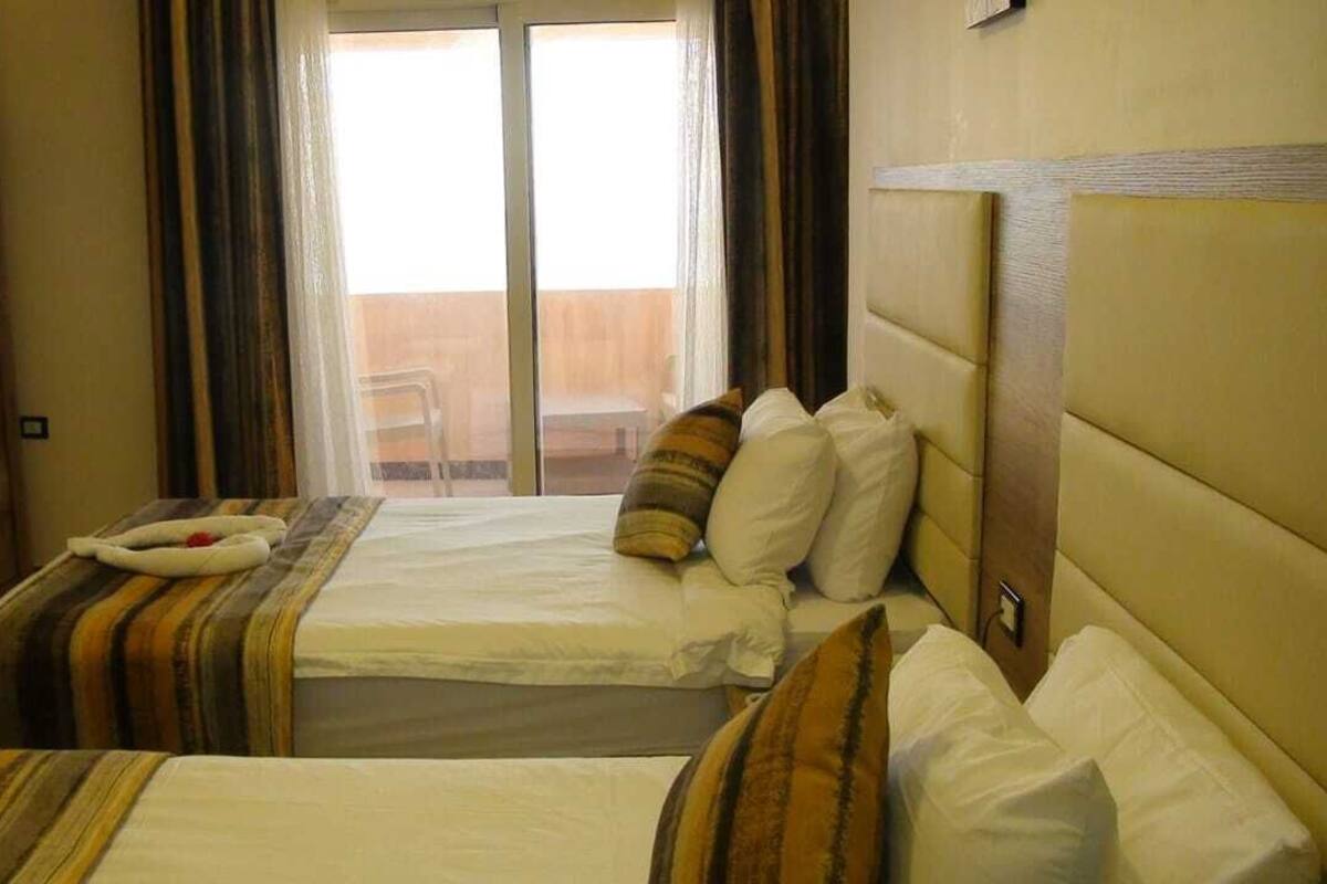 Suite familiar, 3 habitaciones, vistas parciales al mar | Minibar, caja fuerte, ropa de cama