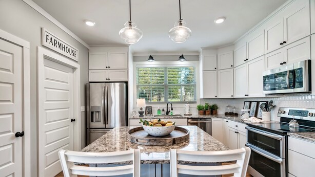 A kitchen with white cabinetry, a stainless steel refrigerator, a built-in oven, and a large window with blinds. - Stunning farmhouse with Mountain View’s! (Sevierville)