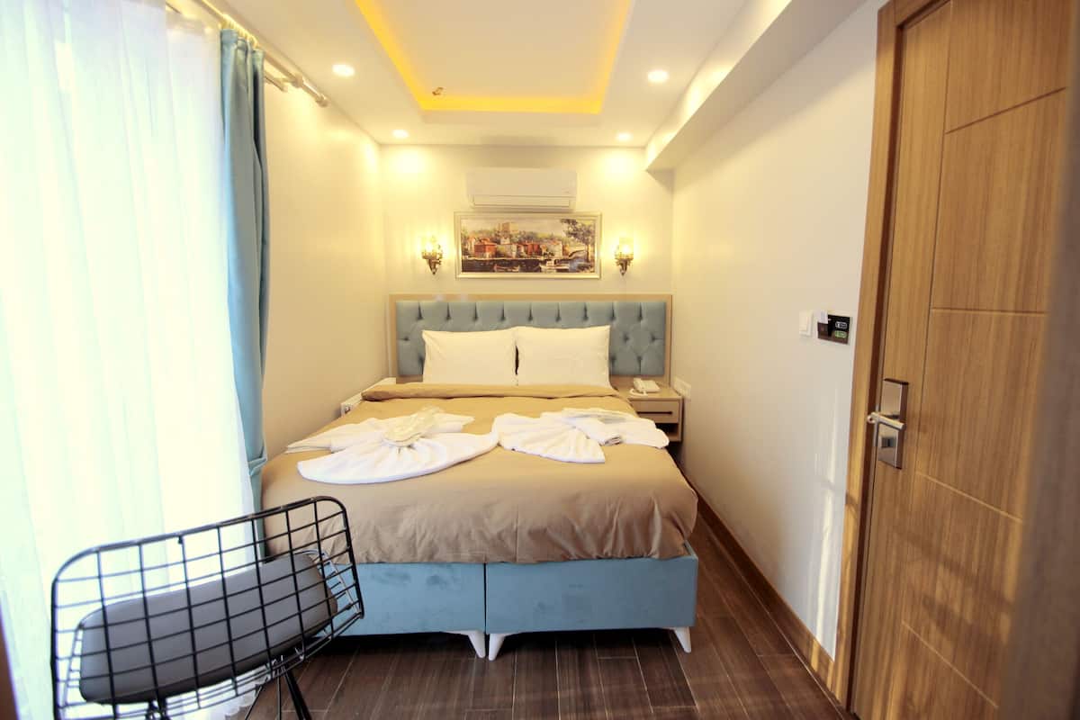 Habitación individual Deluxe, vista al parque | Ropa de cama de alta calidad y minibar
