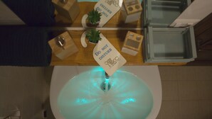A bathroom with a sink, a toilet, and a mirror. There are two signs on the sink, one reads "DO NOT DISTURB" and the other "DO NOT USE". There is a plant on the sink and a towel hanging on the wall. - B&b Oltre l'Arco (Molfetta)