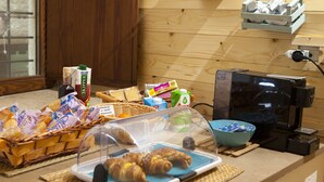 A breakfast setup with bread, pastries, and beverages. - B&b Oltre l'Arco (Molfetta)