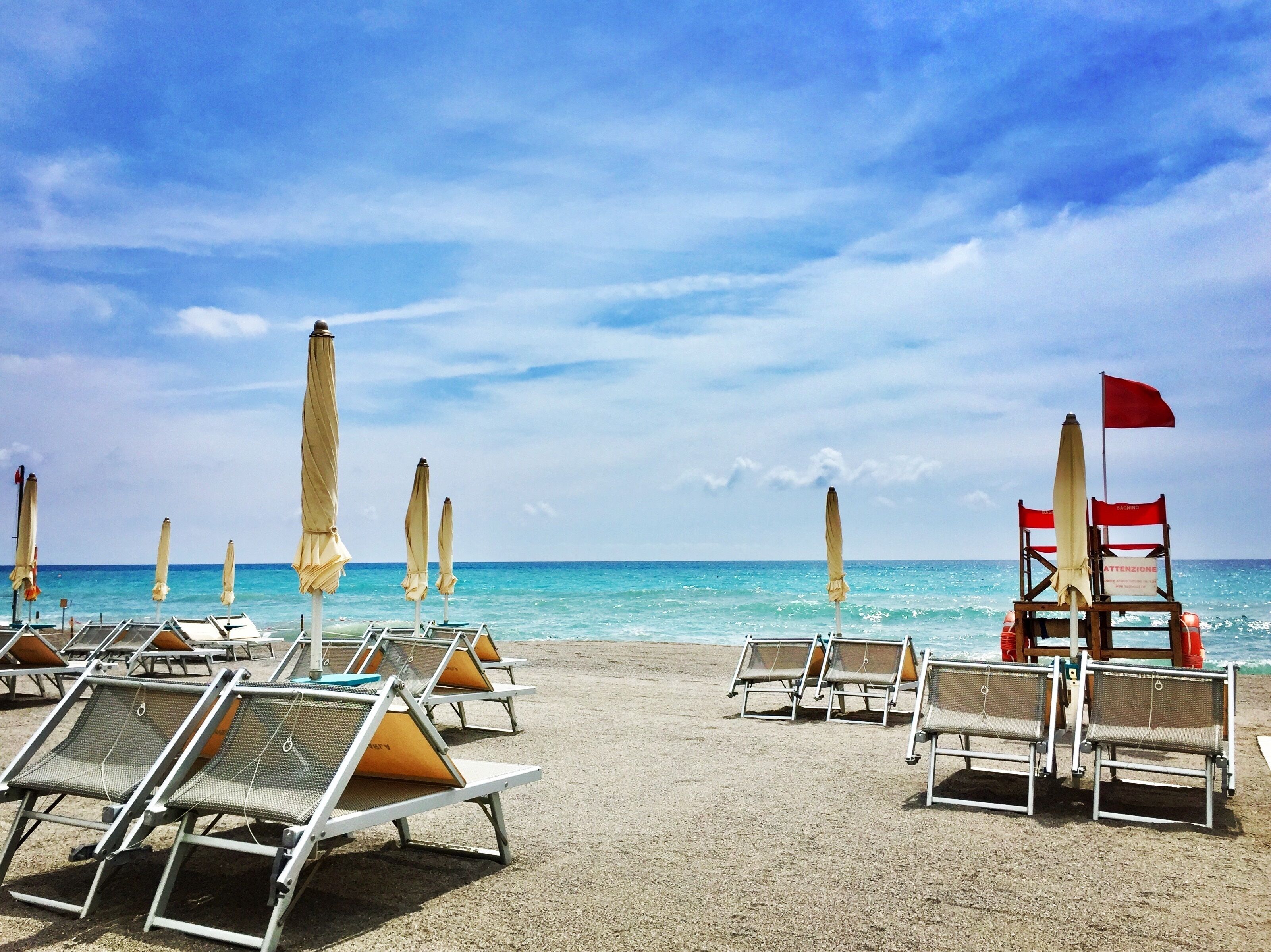 On the beach, sun-loungers, beach umbrellas, beach bar