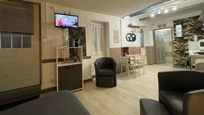 Une chambre d’hôtel équipée d’une télévision, d’un bureau, d’une chaise et d’un lit.