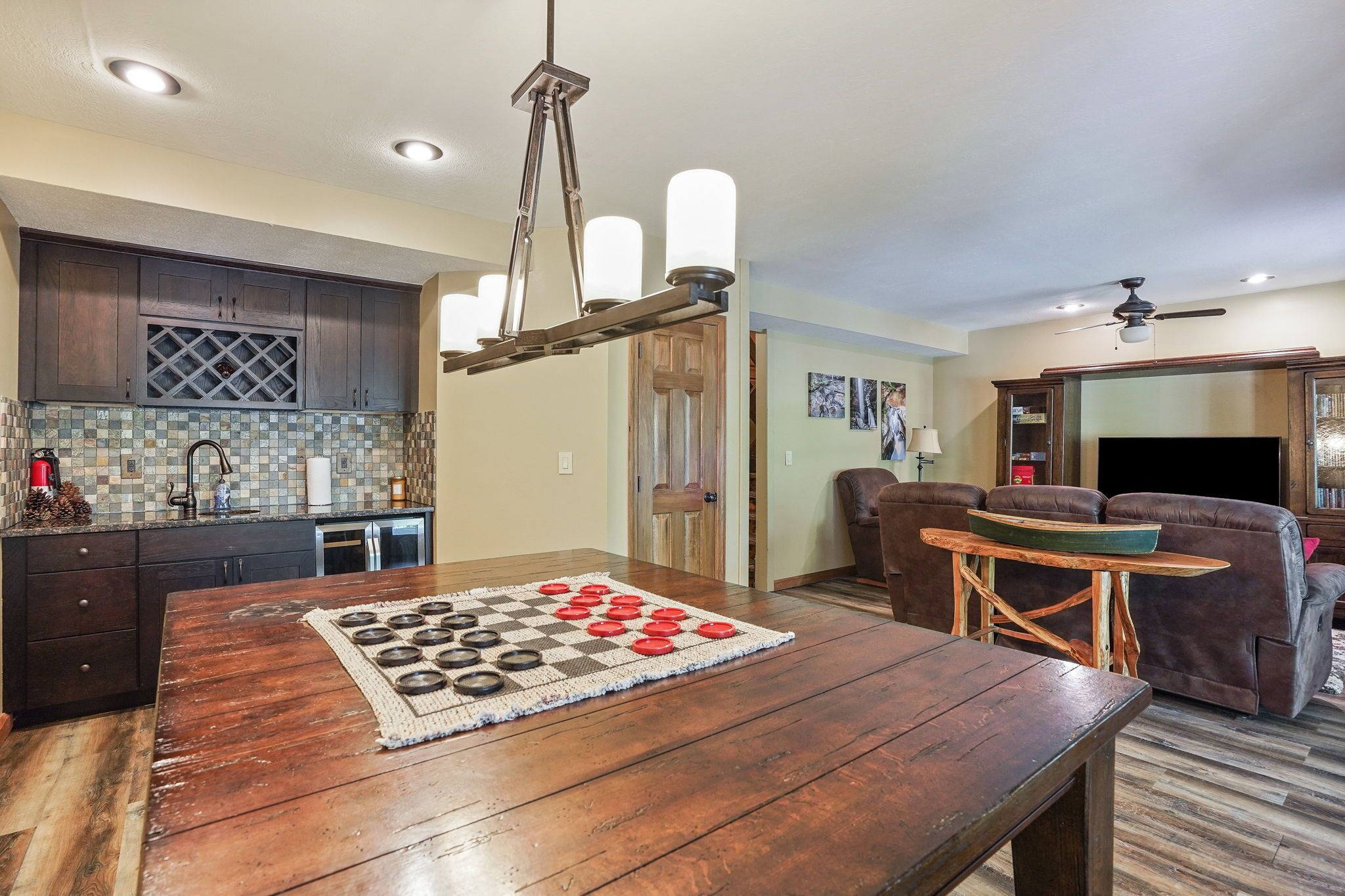 A dining area with a wooden table and a checkered table runner.