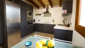 A modern kitchen with a stainless steel refrigerator, built-in oven, and a sink. - QUIET FINCA CAN XAVI (Alcudia)