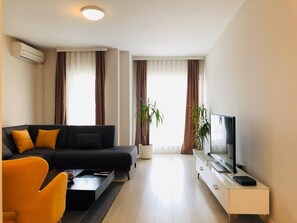 Apartment, 1 Bedroom (2) | Living room | Flat-screen TV