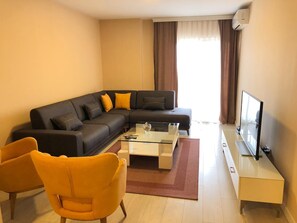 Apartamento, 2 quartos | Área de estar | TV de tela plana