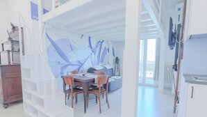 Un interior moderno con comedor, escalera y cocina.