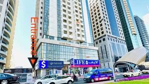 A high-rise building with a prominent entrance labeled "Entrance" and "Al Safa Tower". - Heartland Hostel (Dubai)