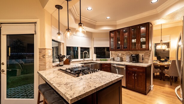 A modern kitchen with granite countertops, stainless steel appliances, and wooden cabinets. - Guarded gated community right across the street from the Waldorf Astoria (Dana Point)
