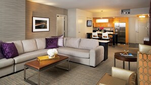 A modern hotel room with a living area, a dining area, and a kitchenette. - Perfect for Conferencing, Shopping, Dining, Shows and the Strip! (Las Vegas)