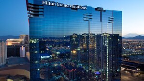 A high-rise hotel with a glass facade, named "Hilton Grand Vacations," featuring a cityscape view. - Perfect for Conferencing, Shopping, Dining, Shows and the Strip! (Las Vegas)