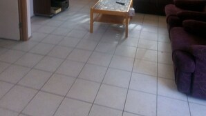 A living room with a television, sofa, and coffee table.