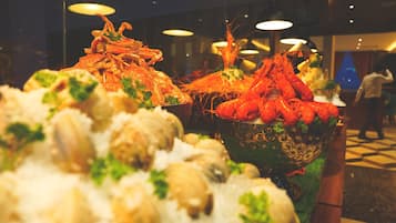 A seafood display with various types of seafood, including lobsters and shrimp, arranged on a bed of ice.