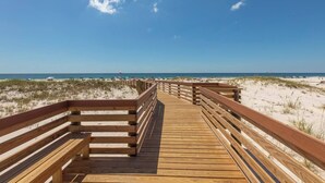 A wooden boardwalk leading to a beach with clear skies. - Beachfront, Indoor Pool & Hot Tub (Gulf Shores)