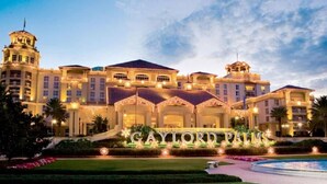 A large, luxurious hotel with a prominent entrance and a well-maintained garden. - 5708 Lakefront Retreat w/ Pool/Jacuzzi Near Disney (Kissimmee)