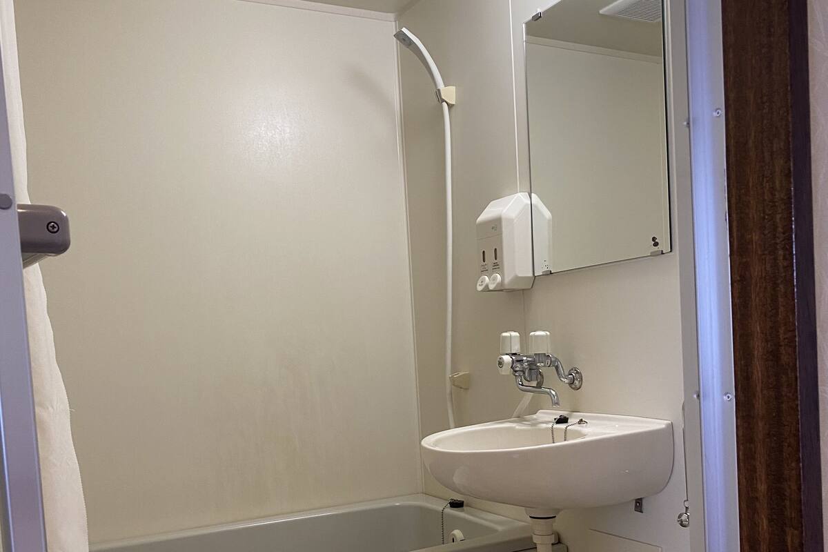 A bathroom with a bathtub, a sink, and a toilet.