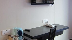A compact kitchenette with a refrigerator, a coffee maker, and a phone on a small table. - Good Hope Hotel Kelana Jaya (Petaling Jaya)