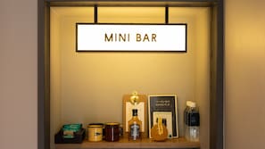 A mini bar with a sign, a bottle of Jack Daniel's whiskey, a mug, a jar of honey, a bottle of water, and a box of tea. - Riverside Lodge (Uwajima)