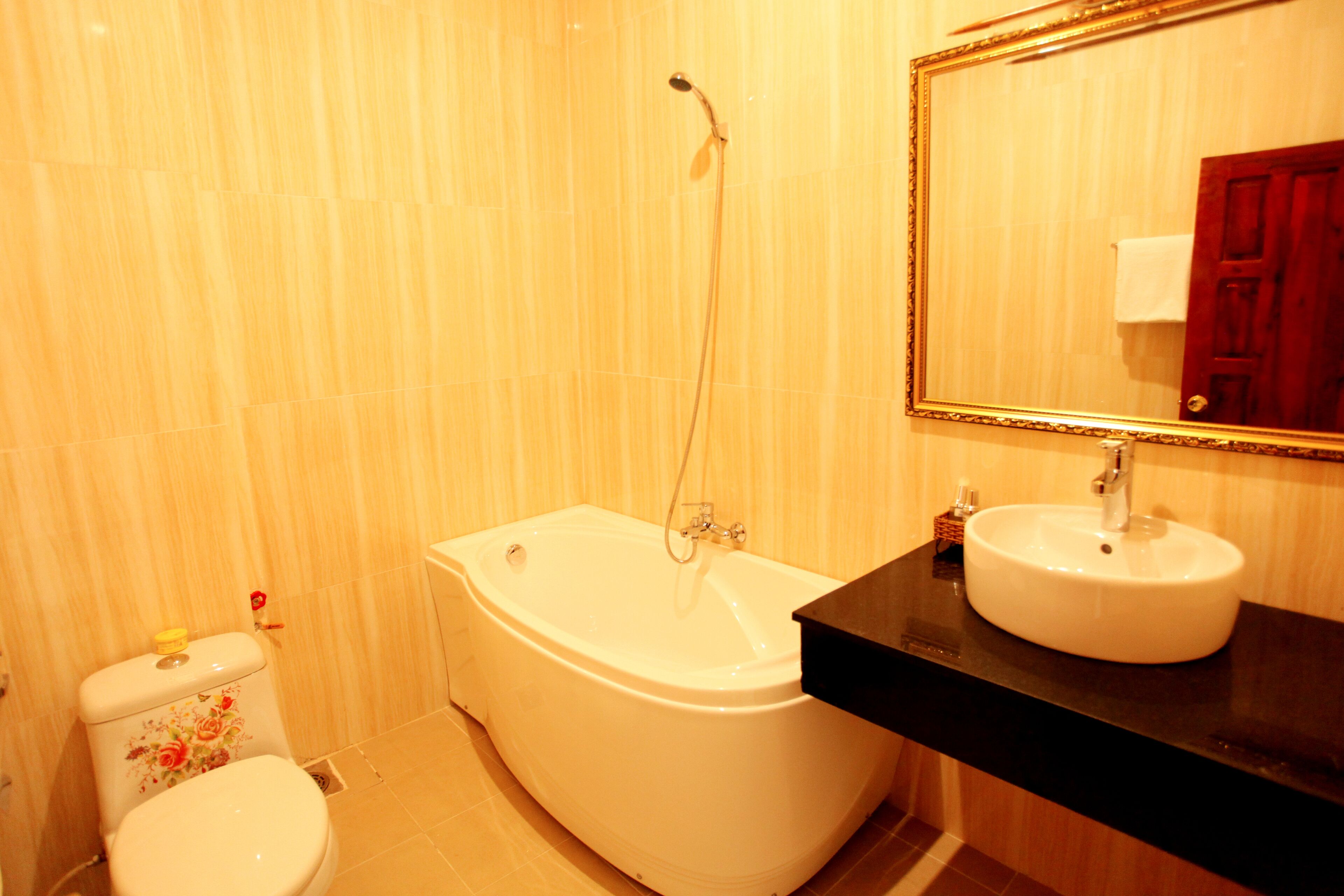 A bathroom with a white bathtub, a sink, and a toilet.