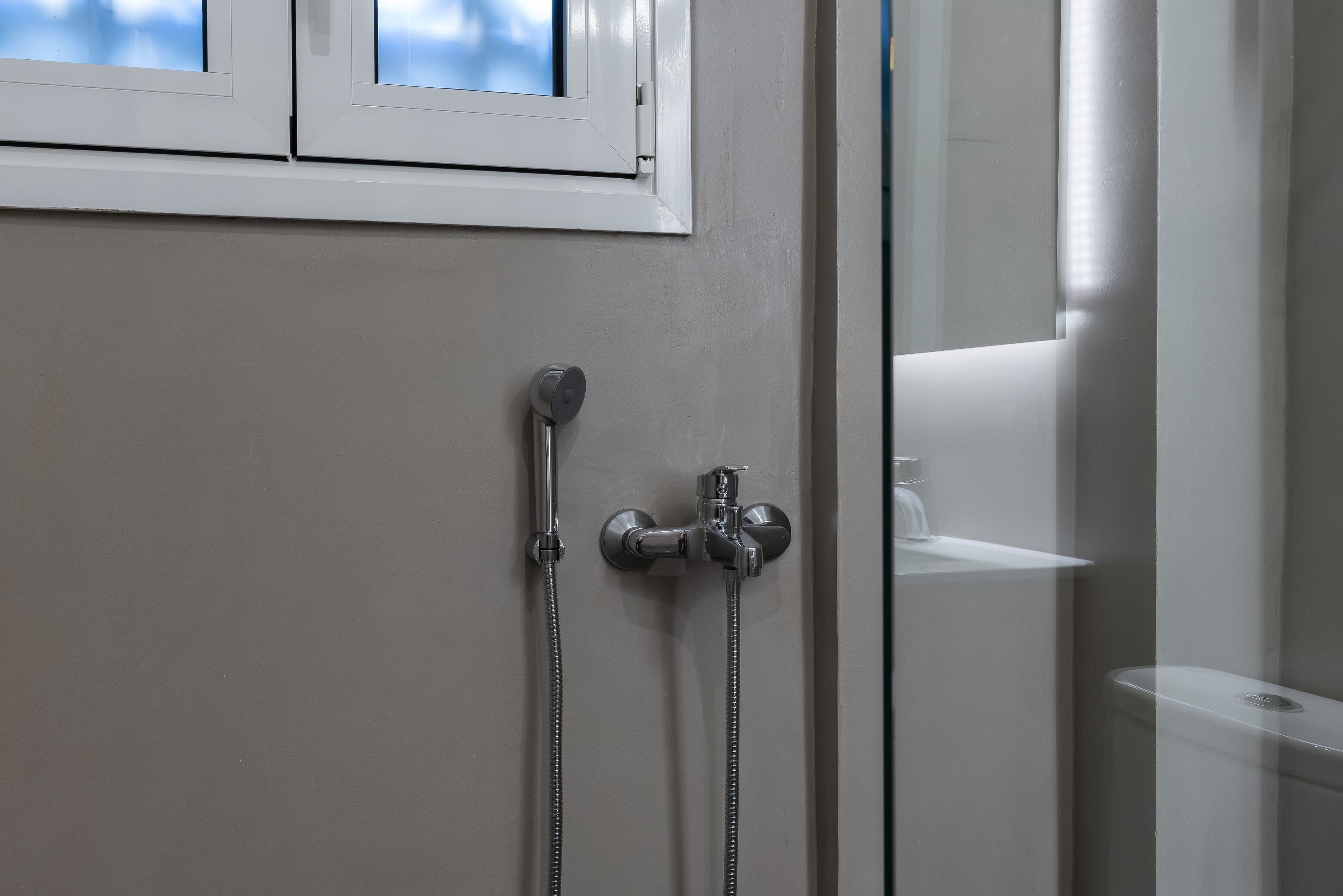 A bathroom with a shower, a toilet, and a sink.