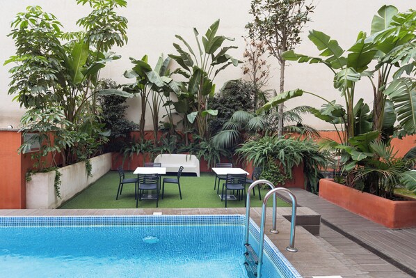 Outdoor pool, open 9:00 AM to 10:00 PM, pool umbrellas, pool loungers