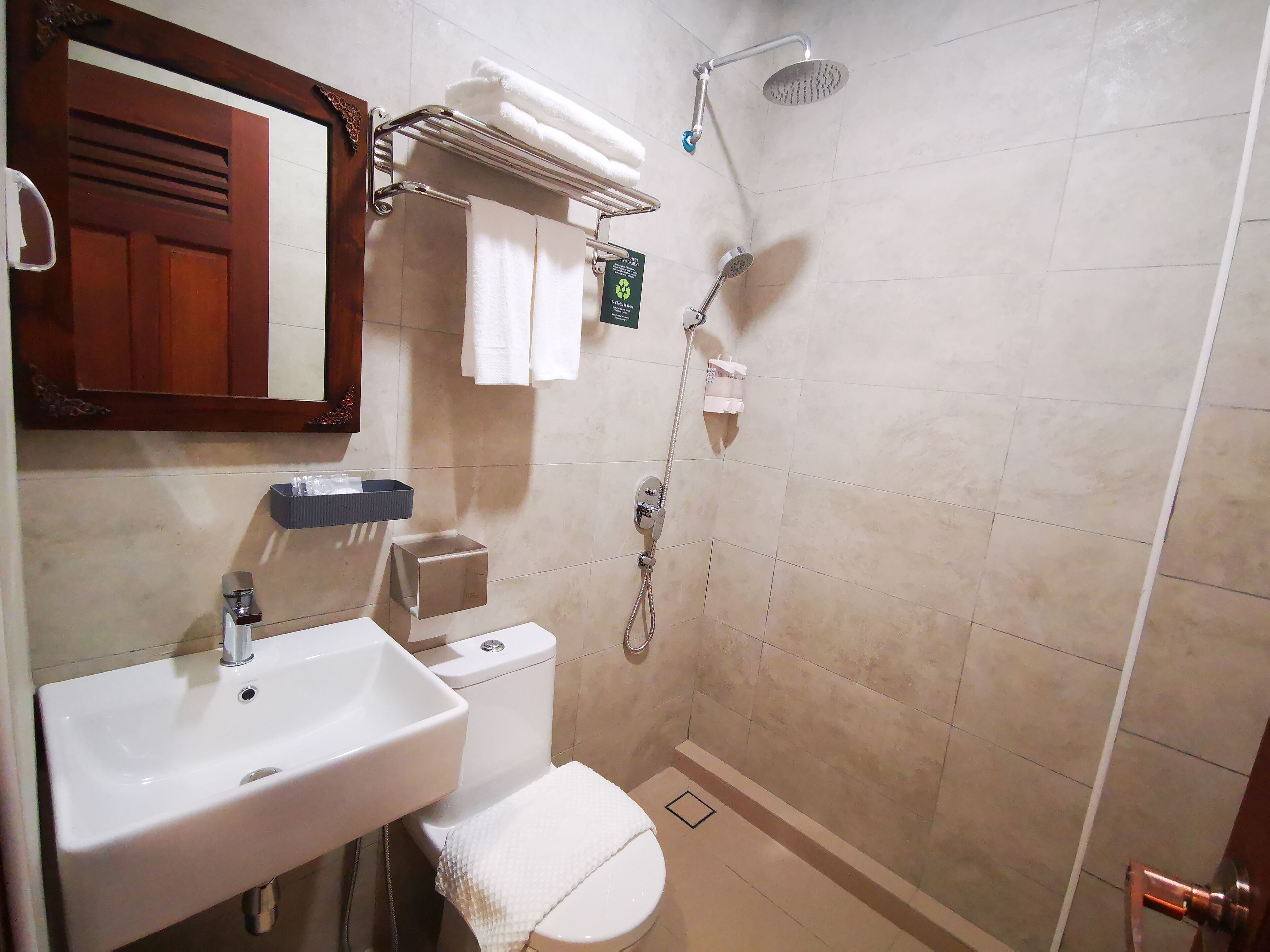 A bathroom with a sink, toilet, and shower.