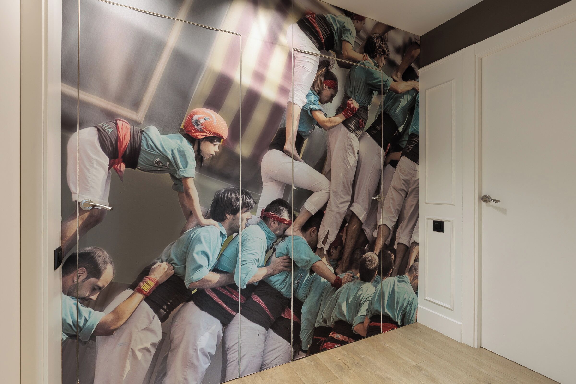 A room with a large mural depicting a group of people in athletic attire.