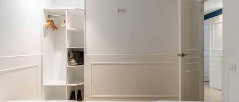 A bedroom with a bed, a wardrobe, and a closet.