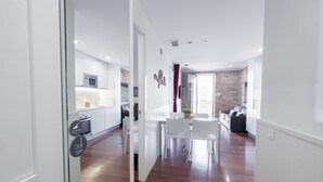 A modern apartment with a kitchen, dining area, and living room. - Enjoybcn Gaudi Apartments (Barcelona)