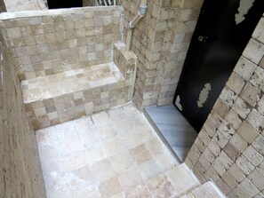 A staircase with beige tiles leading to a dark door, surrounded by beige walls and a metal handrail. - Istanberry - Pera Apartments (Istanbul)