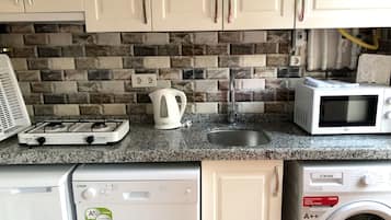 Superior Apartment (1st Floor) | Private kitchen | Fridge, highchair, cleaning supplies, freezer
