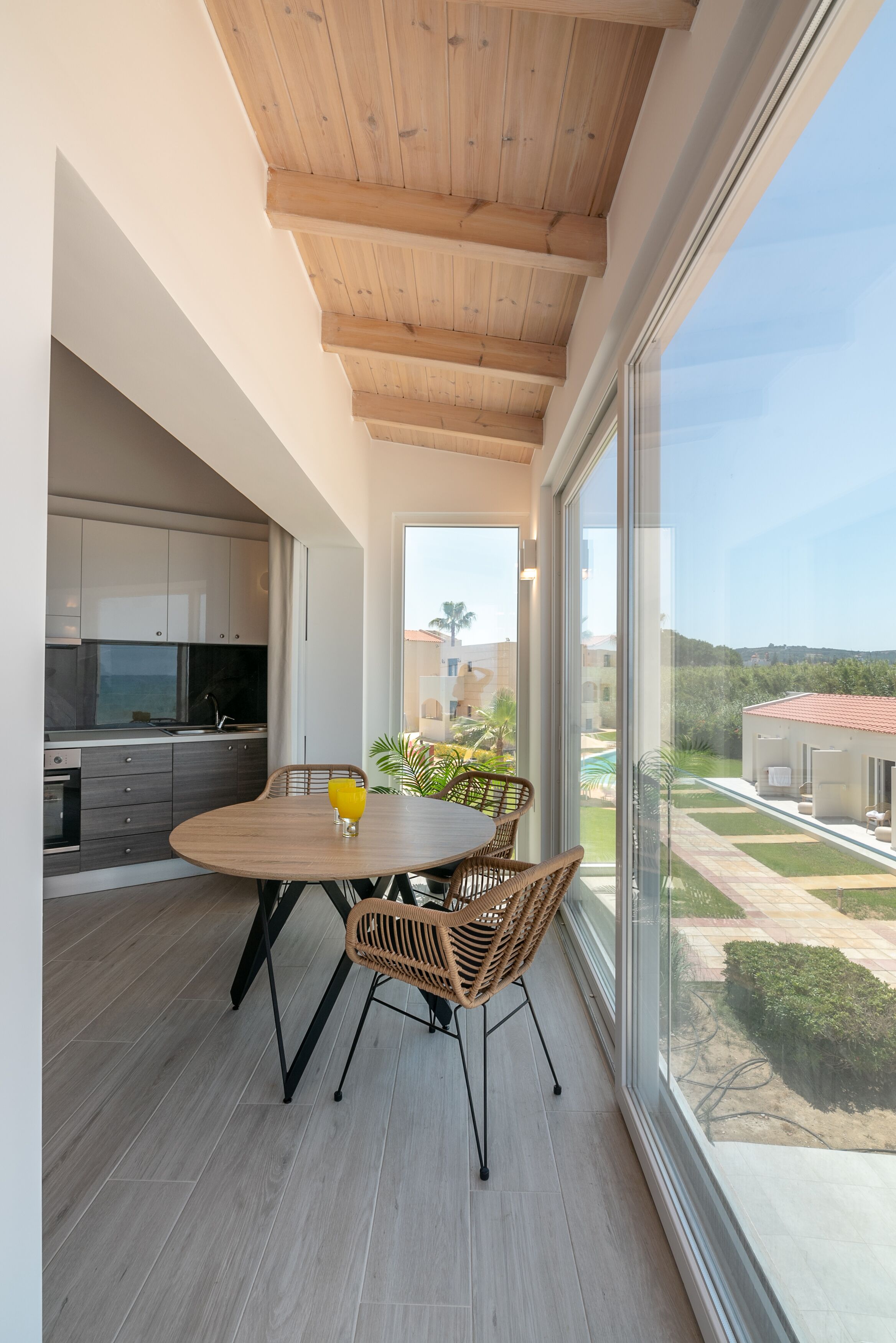 Una cocina moderna con armarios blancos y techo de madera.