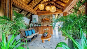 Un'ampia hall con soffitto alto, una reception e un'area salotto con divano e poltrone.
