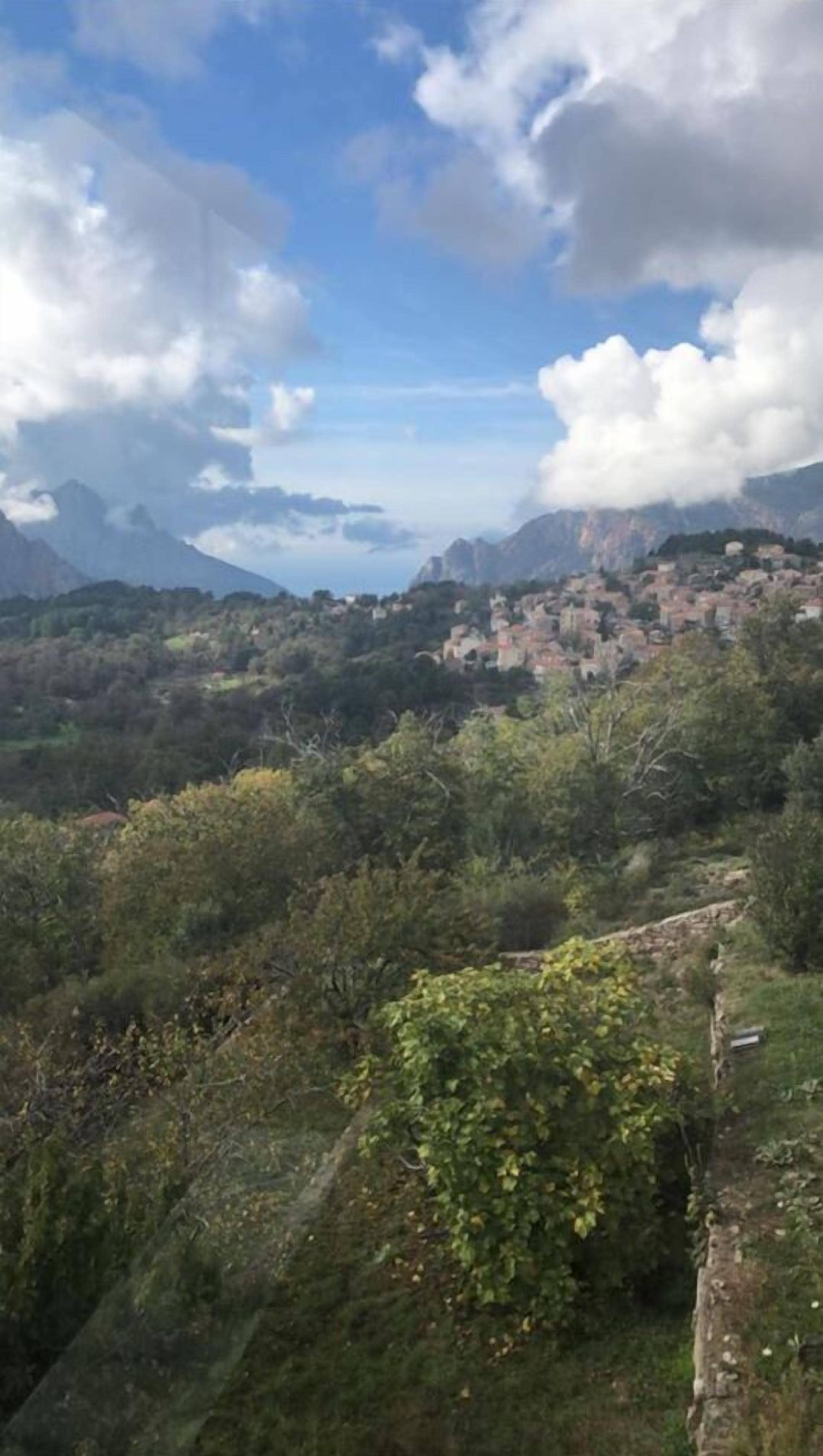 A mountainous landscape with a village nestled in the valley.